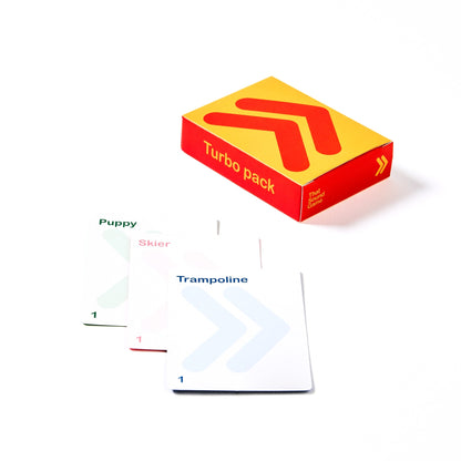 A box labeled "Turbo pack" with cards showing abstract shapes and words like "Puppy" and "Trampoline."